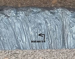 Brownish green olivine crystal buried under Fe-Ni before acid etching